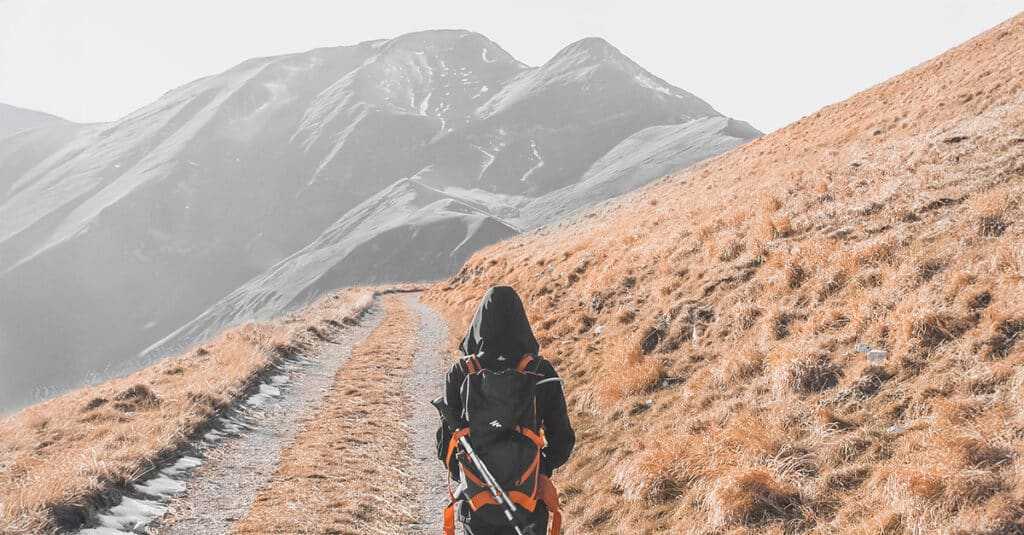 Person approaching mountain.