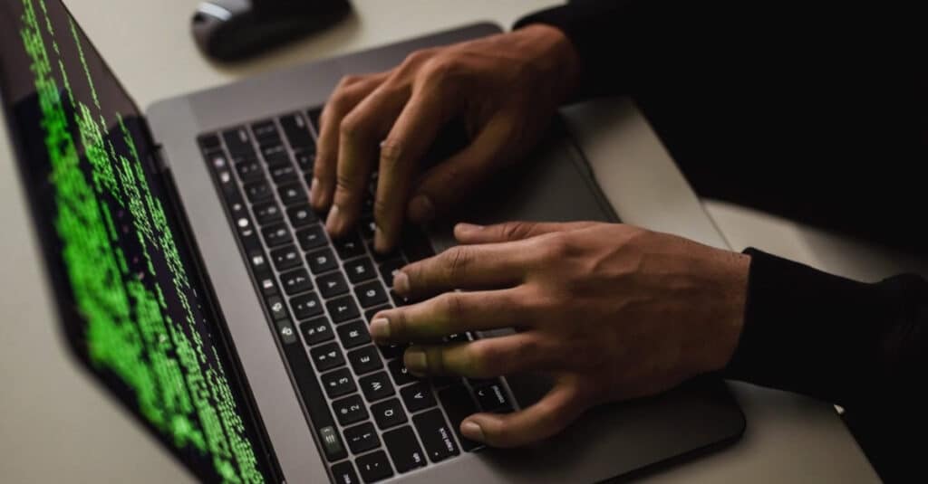 hands typing on a laptop