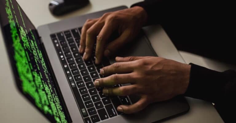 hands typing on a laptop