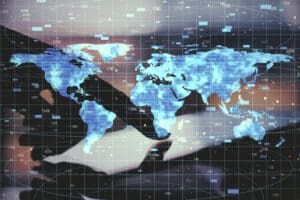 Close-up of a hand using a backlit tablet displaying digital data