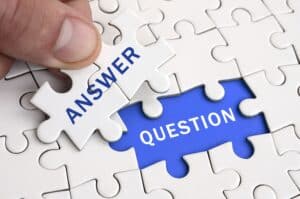 Puzzle pieces labeled "Answer" and "Question" representing organizations seeking evidence-based security answers about exploitability and cyber risk.